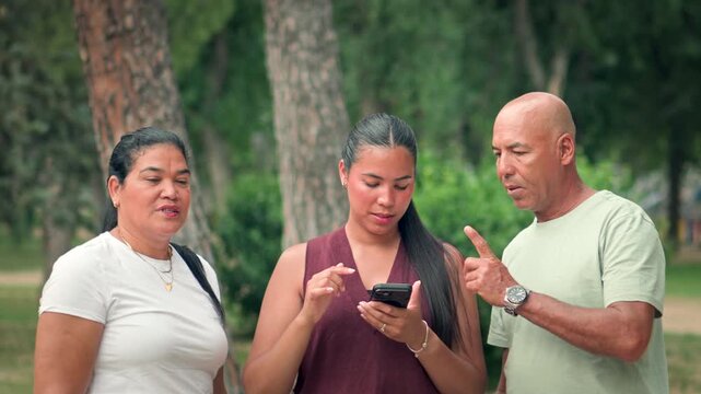 Family using smartphone map to find directions in public park