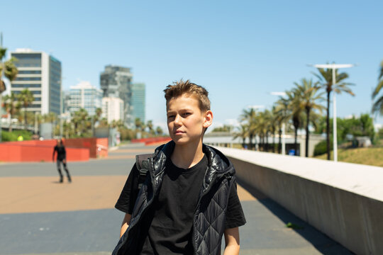 Teenager walking through the city, outdoors