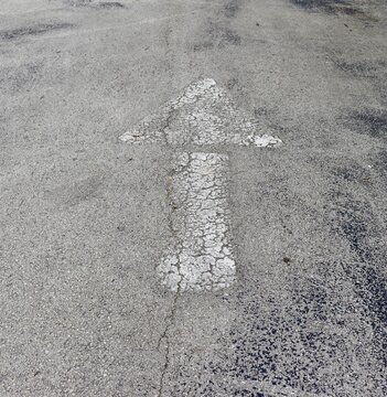 The white arrow on the pavement.