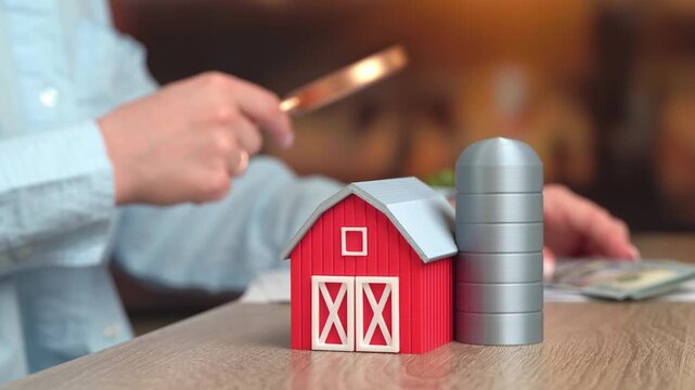 A businesswoman works with documents and a farm is in the foreground. Financial analysis in agriculture, profitability assessment, cost control, fiscal pressure, strategic planning.