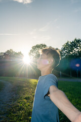 Profile of teenage boy with eyes closed breathing at sunrise, conceptual shot for youth wellness stress relief and inner peace © alaa