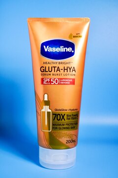 Jakarta, Indonesia - June 17th, 2026 - Vaseline healthy bright serum burst lotion tube isolated on vertical blue background.