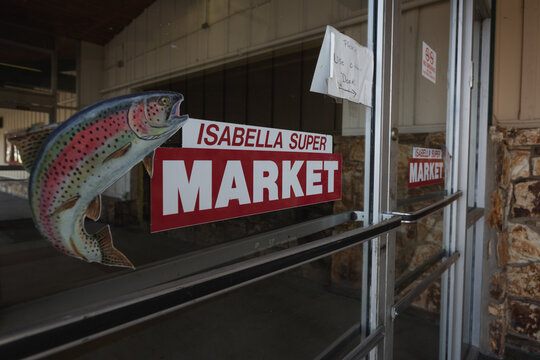 Entrance to a vintage IGA supermarket featuring a fish sign, Lake Isabella, California, March 2020