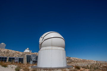 Fototapeta premium Space Observation Facility and Observatory Domes. Astronomical Observatory Complex Under Clear Sky. Scientific Observatory Buildings and Telescope Domes.