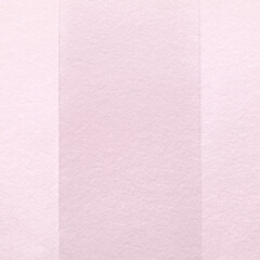 Fototapeta premium Textured pink paper with vertical stripes in varying shades.