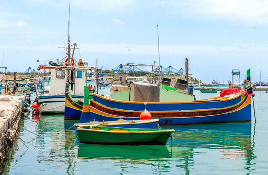 Colorful fishing boats docked in Valetta harbor
