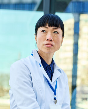 Portrait of a female woman doctor or nurse and  health care worker in front of hospital or clinic outside