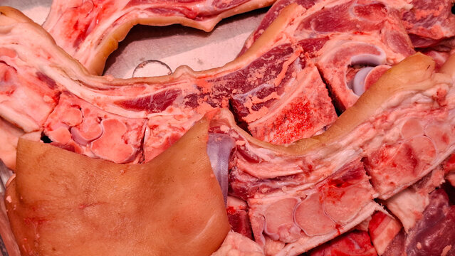 Fresh raw pork spine bones with rind attached ready for boiling traditional spicy broth and rich soup stock preparation