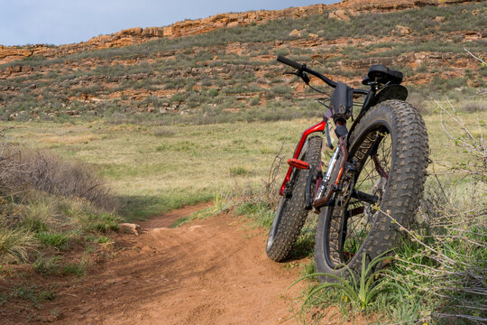 fat mountain bike on a trail in grassy foothills of Colorado, spring scenery