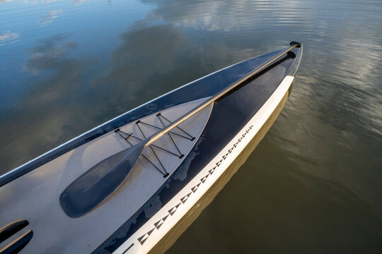 touring stand up paddleboard with a paddle on a calm lake