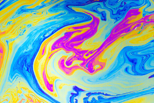 Abstract fluid swirl, colorful paint pattern, blue yellow magenta marbling, vibrant liquid texture, flowing wave design, modern background art