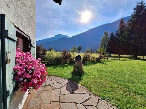Flower decorated alpine guesthouse terrace with mountain view in Tyrol, Austria