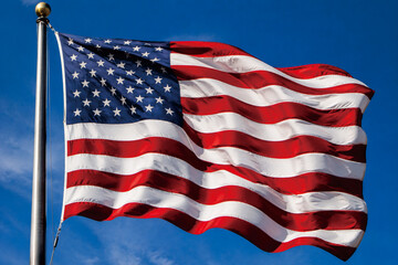 Obraz premium United States Stars and Stripes Flag Flying Proudly in Bright Daylight