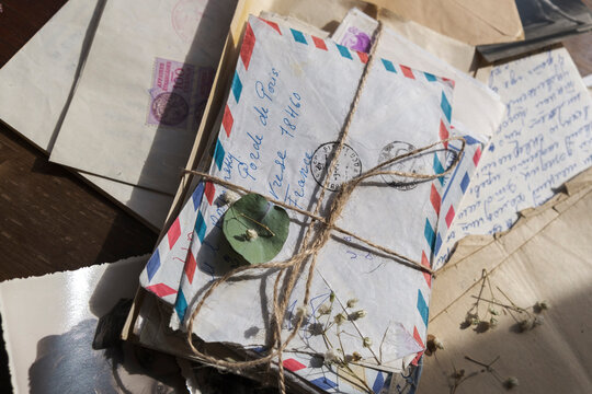 Collection of old handwritten airmail letters tied with rustic twine.