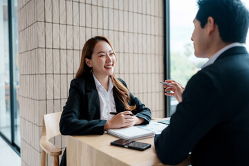Asian businesswoman meeting employer, discussing career opportunities. Professional interaction...