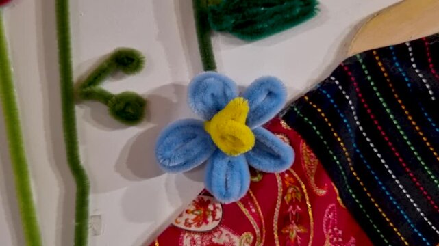 Handmade pipe cleaner flower arrangement with vibrant colorful fabric details