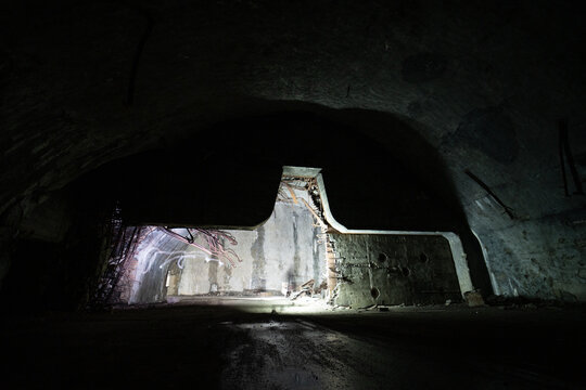View of the abandoned underground aircraft hangar at Zeljava Aerodrome with concrete walls and debris in Zeljava, Licko-senjska zupanija, Croatia.