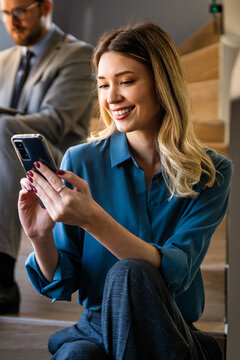 Smiling successful business woman, freelancer, coworker female leader using digital device, phone
