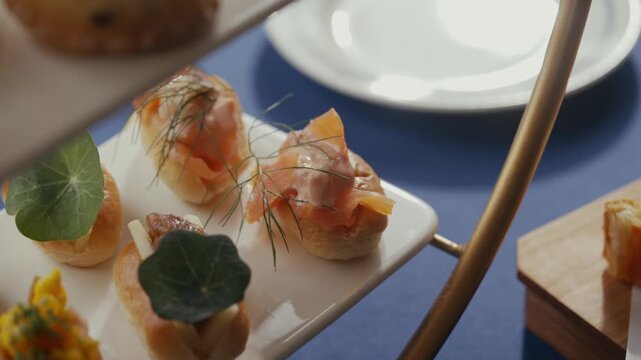 Elegant appetizers on white plates for an afternoon tea gathering