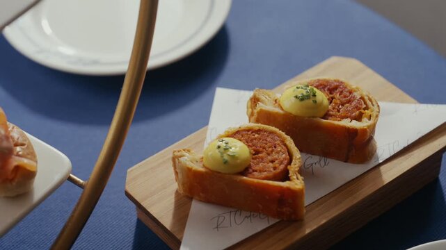 Close up of savory toast bites with herb butter on wooden board