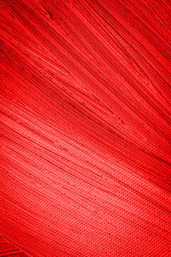 Bright red texture shows smooth strokes and lines on a surface during a sunny afternoon