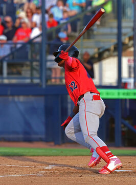 baseball player hitting and running