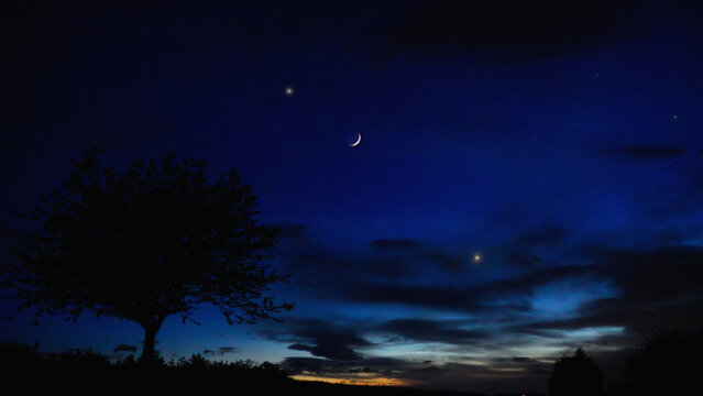 Crescent Moon, planet conjunction and landscape scenery silhouettes.