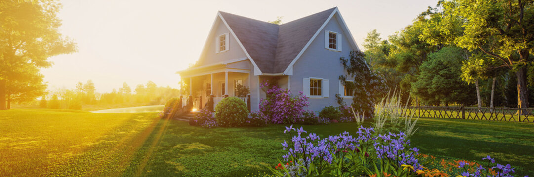 Sunlit country house with garden at golden hour