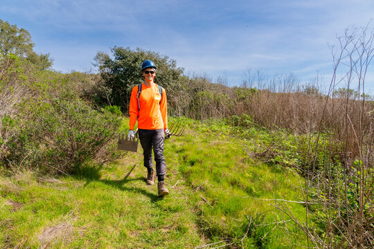 trail construction worker surveying land 