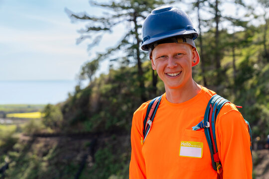 smiling portrait construction worker outside safety hard hat