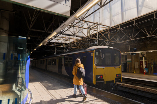 Woman Walking at Railway Station With Suitcase 