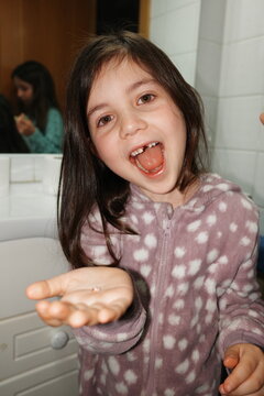 Excited Child Celebrating Lost Tooth in Bathroom