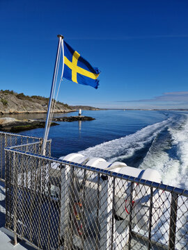 Swedish Flag Waving on a Ferry in the Archipelago