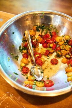 Food prep of tomato salad in metal  bowl