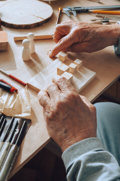 Senior carpenter working with wood.