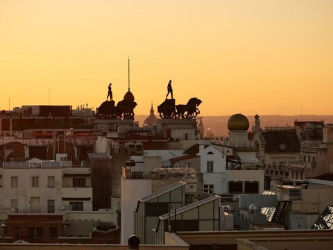 Chariot statues seen on the rooftop of Madrid