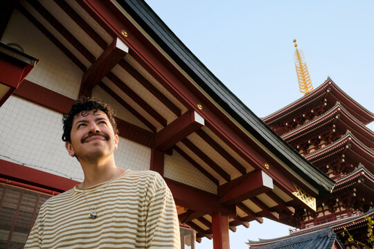 Traveler standing near historic Tokyo pagoda temple