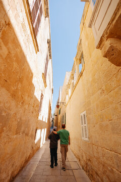 Father and son walking in Malta