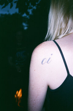 Back view of a person with a tattoo on the shoulder