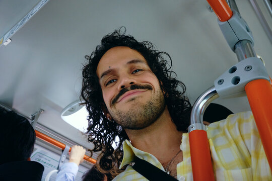 Smiling traveler riding public bus in Tokyo