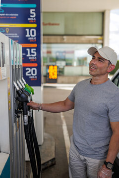 Middle aged man refueling with diesel at a gas station