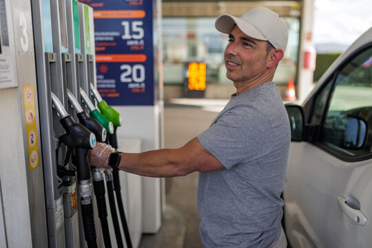 Middle aged man refueling with diesel at a gas station