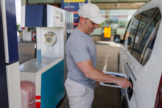 Man refueling his van with diesel at a gas station