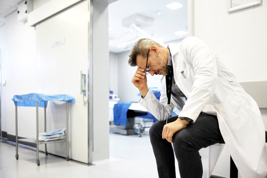 Doctor Sitting in Hospital deep in thought