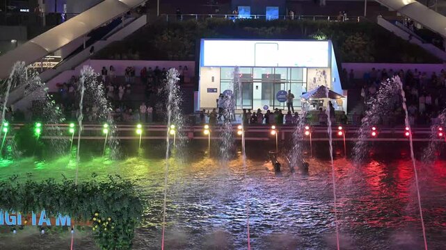 Tashkent, Uzbekistan - June 08, 2026: Seoul Mun Street.  Colorful fountain show with spectators enjoying evening performance.