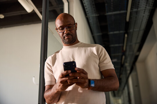 Man sends texts from his phone at the office