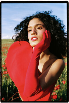 Woman posing with red heart shape top