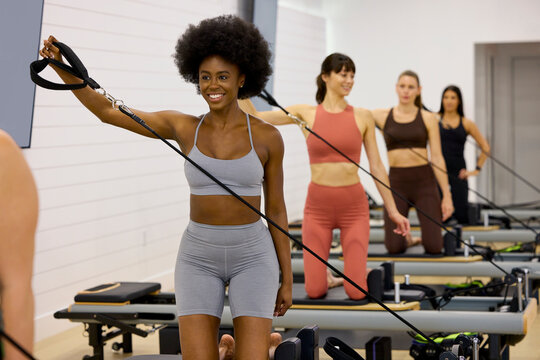 A group of women take part in a pilates class in a studio