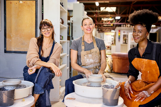 Three People Make Pottery in a Studio