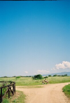 Person Reading on a Bench in an Open Sardinian Landscape